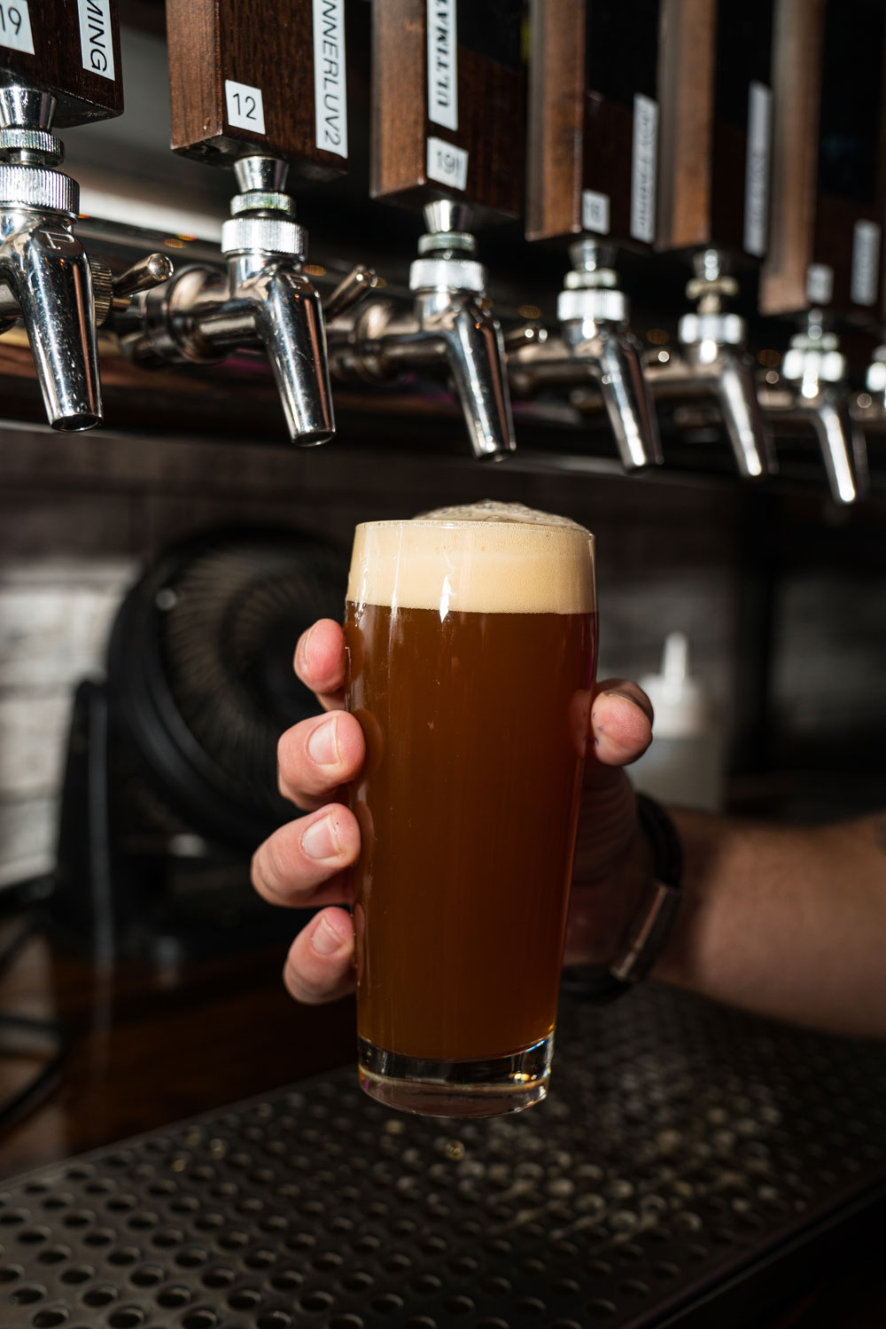 Close up of full beer glass under tap